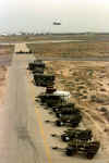 BLU-109 penetrating bombs, Mark 84 general purpose bombs, AGM-65 Maverick, AIM-7 Sparrow and AIM-9 Sidewinder missiles are pre-positioned for quick loading onto aircraft near the runway at Ahmed Al-Jaber Air Base, Kuwait, on March 6, 1998. An A-10 is taking off in the background. DoD photo.