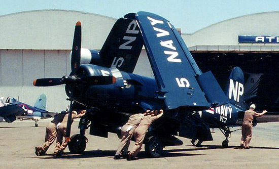 Ground crews help move the Collings Foundation's F4U-5NL on the ramp.